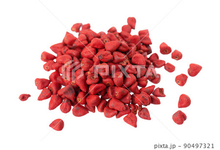 Annatto seeds, isolated on a white background. Achiote seeds, bixa orellana. Natural dye for cooking and food. Close-up. Top view. 90497321