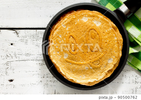 A stack of pancakes in a frying pan, traditional for Russian Carnival 90500762