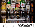 Close-up of a shots of tequila with lime and salt in a bar. 90506071