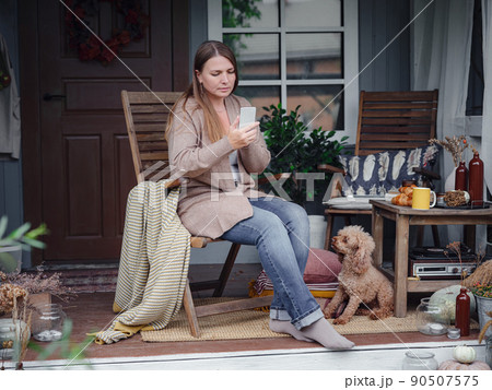 smiling woman with dog outdoors making selfie 90507575