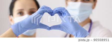 Physicians forming heart with hands Physicians forming heart with hands 90508951