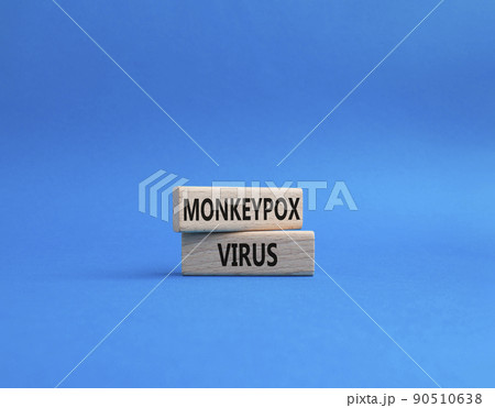 Monkeypox virus symbol. Concept word Monkeypox virus on wooden blocks. Beautiful blue background. Medicine and Monkeypox virus concept. Copy space 90510638
