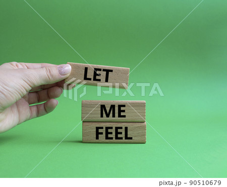 Feel symbol. Wooden blocks with words 'Let me feel'. Beautiful green background. Businessman hand. Psychology and let me feel concept. Copy space. 90510679