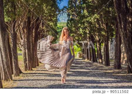 Woman tourist walking in Montenegro. Panoramic summer landscape of the beautiful green Royal park Milocer on the shore of the the Adriatic Sea, Montenegro Woman tourist walking in Montenegro. Panoramic summer landscape of the beautiful green Royal park Milocer on the shore of the the Adriatic Sea, Montenegro 90511502