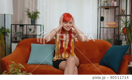 Repair work at neighbours concept, irritated girl at home cover ears with hands annoyed by noise 90511714