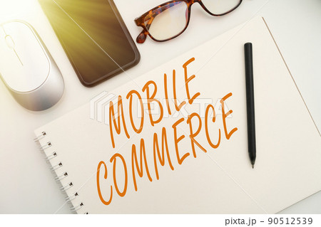 Text sign showing Mobile Commerce. Word Written on Using mobile phone to conduct commercial transactions online Office Supplies Over Desk With Keyboard And Glasses And Coffee Cup For Working Text sign showing Mobile Commerce. Word Written on Using mobile phone to conduct commercial transactions online Office Supplies Over Desk With Keyboard And Glasses And Coffee Cup For Working 90512539