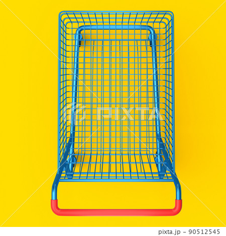 Shopping cart or trolley for groceries on yellow background. 90512545