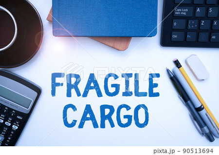 Writing displaying text Fragile Cargo. Concept meaning Breakable Handle with Care Bubble Wrap Glass Hazardous Goods Office Supplies Over Desk With Keyboard And Glasses And Coffee Cup For Working 90513694