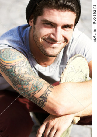 Your body is a temple - decorate it. Portrait of a young man showing off his beautiful Art Nouveau style tattoo. 90516271