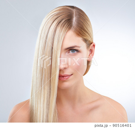 No split ends here. A gorgeous young blonde woman posing against a white background. 90516401