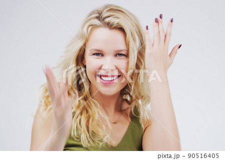 Feel the rhythm taking over. Studio portrait of an attractive young woman feeling cheerful and dancing against a grey background. Feel the rhythm taking over. Studio portrait of an attractive young woman feeling cheerful and dancing against a grey background. 90516405