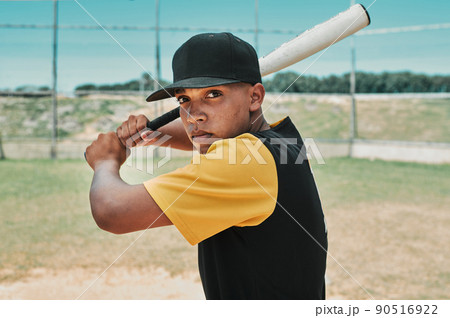 Its time to hit hard and run fast. Shot of a young baseball player holding a baseball bat while posing outside on the pitch. 90516922