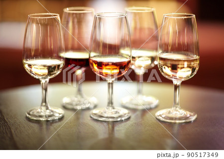 The many varieties of wine. Shot of five glasses of different wines on a table. 90517349