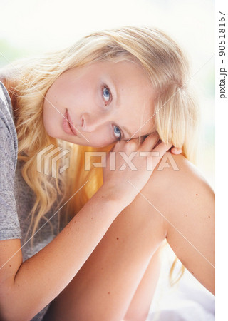 Natural beauty. A gorgeous young woman sitting in her bed looking at the camera. Natural beauty. A gorgeous young woman sitting in her bed looking at the camera. 90518167