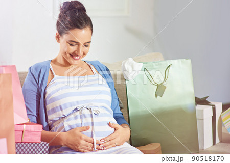 Her baby is also enjoying the celebrations. Shot of a young pregnant woman at her baby shower. 90518170