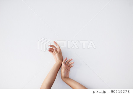 Your hands are your best tools. Cropped shot of a unrecognizable persons hands against a grey background stretching up. 90519278