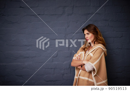 She knows what she wants. Shot of a woman standing against a dark background. She knows what she wants. Shot of a woman standing against a dark background. 90519513