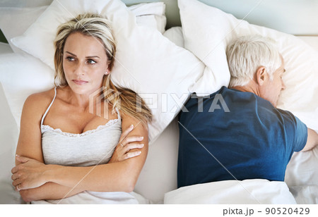 I cant just sleep our problems away like he does. Shot of a mature couple having marital problems at home. I cant just sleep our problems away like he does. Shot of a mature couple having marital problems at home. 90520429