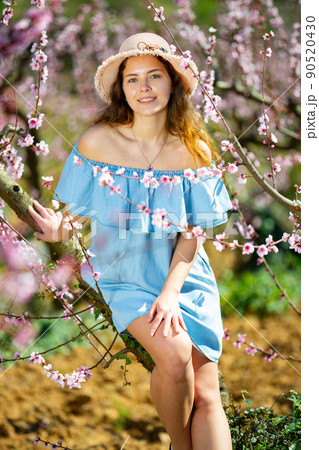 Woman in straw hat enjoying the nature in spring 90520430