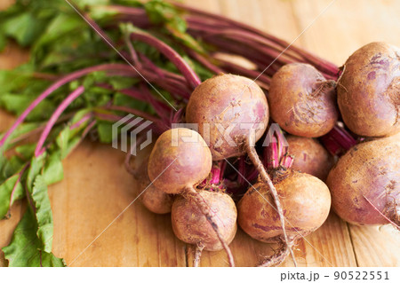 Good eats. Closeup shot a bunch of radishes on a cutting board. 90522551