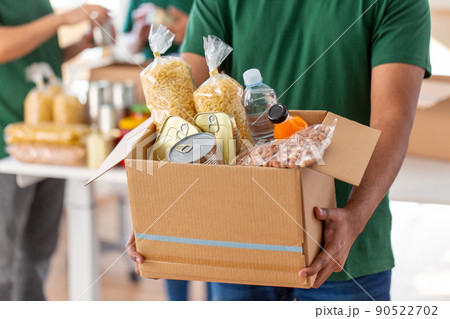 close up of volunteer holding box with food close up of volunteer holding box with food 90522702