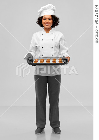 happy female chef with cookies on oven tray happy female chef with cookies on oven tray 90523074