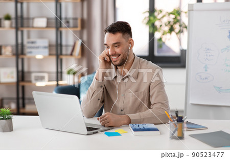 teacher with laptop and earphones working at home teacher with laptop and earphones working at home 90523477