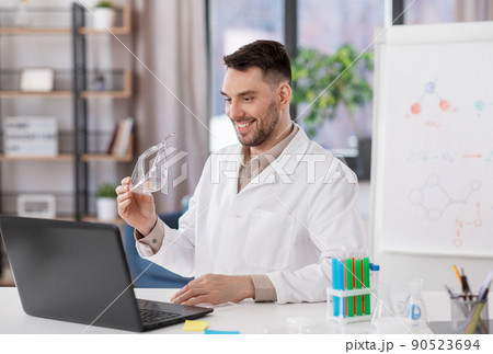 chemistry teacher with laptop having online class chemistry teacher with laptop having online class 90523694