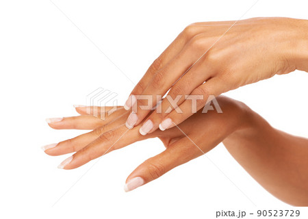 Loving the soft feeling of her skin. A young woman feeling her silky, smooth skin while isolated on a white background. 90523729