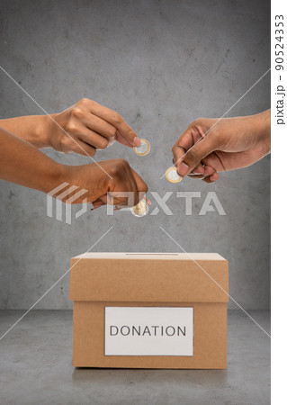 close up of hands putting coins into donation box close up of hands putting coins into donation box 90524353