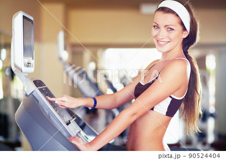Stepping my way to fitness. An attractive young woman using a step machine in the gym. Stepping my way to fitness. An attractive young woman using a step machine in the gym. 90524404