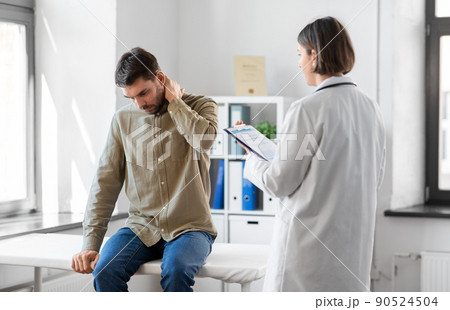 man patient showing sore arm to doctor at hospital man patient showing sore arm to doctor at hospital 90524504