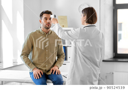 doctor with thermometer and man at hospital 90524539