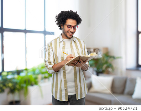 happy smiling man with diary and pencil at home happy smiling man with diary and pencil at home 90524721