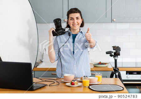 food photographer with camera working in kitchen 90524783