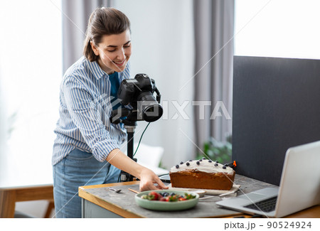 food photographer with camera working in kitchen 90524924