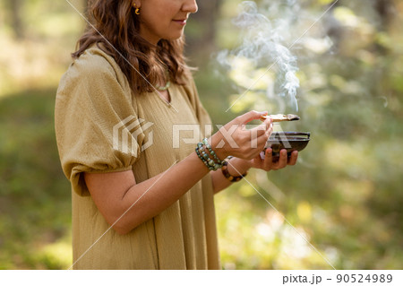 woman with palo santo performing magic ritual woman with palo santo performing magic ritual 90524989