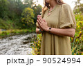 woman or witch performing magic ritual on river 90524994