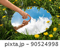 hand touching sky reflection in mirror on field 90524998