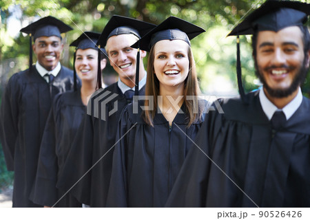 Theyre proud graduates. A group of happy students on graduation day. 90526426