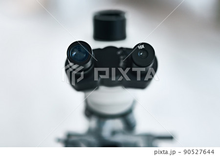 Place your eyes as close as you can. Still life shot of the eyepiece on a microscope in a laboratory. 90527644