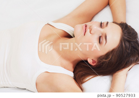 Catching some shut-eye. Shot of a young woman sleeping on her bed. Catching some shut-eye. Shot of a young woman sleeping on her bed. 90527933