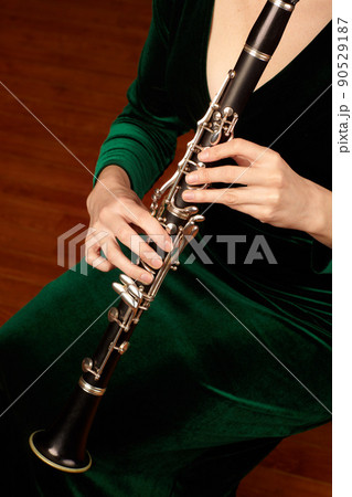 Woodwind wonder. A cropped image of a woman playing a clarinet. 90529187