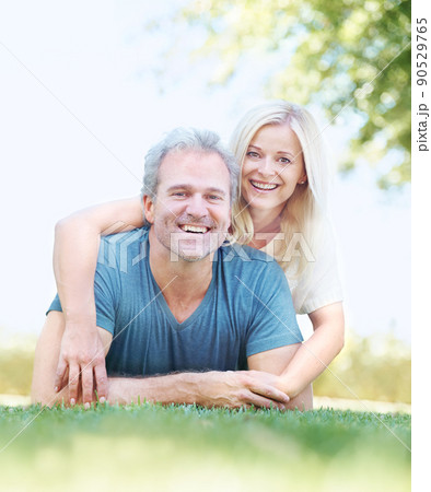 As in love as the day they met. Portrait of a mature man enjoying his wifes affections in the park. As in love as the day they met. Portrait of a mature man enjoying his wifes affections in the park. 90529765
