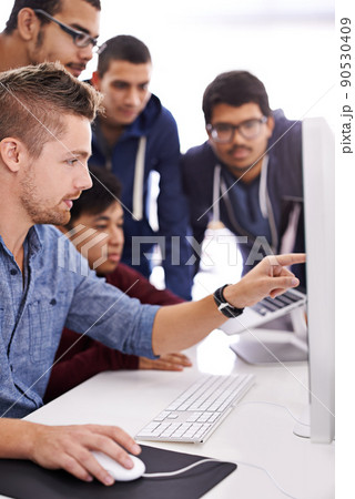 Need solutions This is the team you want supporting you. Shot of a group of colleagues working together with a computer in an office. 90530409