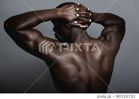 Solid as a rock. A handsome and muscular young man posing in the studio. Solid as a rock. A handsome and muscular young man posing in the studio. 90530702