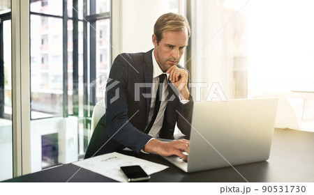 Focused on the task at hand. Shot of a businessman using his laptop. Focused on the task at hand. Shot of a businessman using his laptop. 90531730