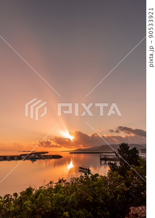 Amazing sunrise in the seaside harbor, sunbeams spreading in the sky, boats in the smooth sea. Amazing sunrise in the seaside harbor, sunbeams spreading in the sky, boats in the smooth sea. 90533921