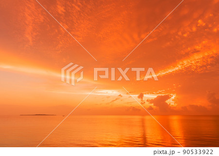 Gorgeous seascape sunrise, clouds and sea in orange shades, island in the background. Gorgeous seascape sunrise, clouds and sea in orange shades, island in the background. 90533922