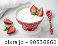 fresh homemade greek yogurt with fresh strawberries in a red bowl 90536860